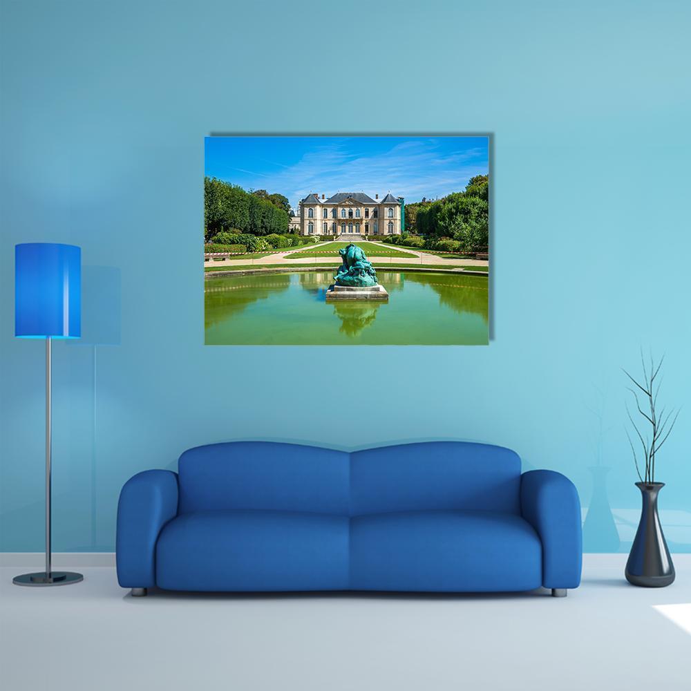 Manor House with Sculpture Fountain and Reflecting Pond Canvas Wall Art in beige, green and blue, single panel hung on a wall