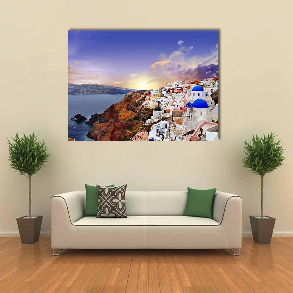 Santorini Sunset Over Oia Blue Domes Canvas Wall Art in white, orange and blue, single panel hung on a wall