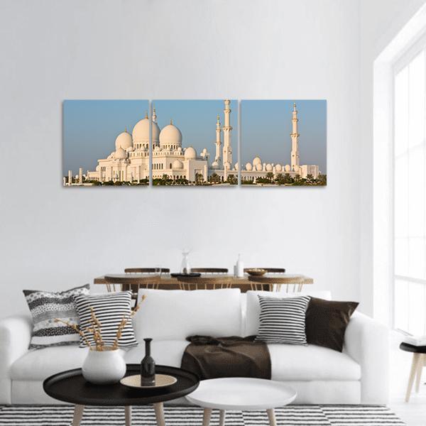 Sheikh Zayed White Mosque Panoramic Canvas Wall Art in white and blue, hung on a wall