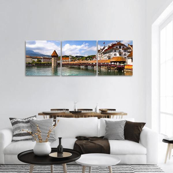 Chapel Bridge with Octagonal Water Tower Panoramic Canvas Wall Art in white, brown and blue, hung on a wall