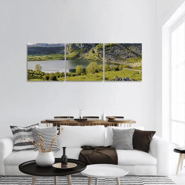 Lake Enol Mountains and Meadows Panoramic Canvas Wall Art in gray, green and blue, hung on a wall