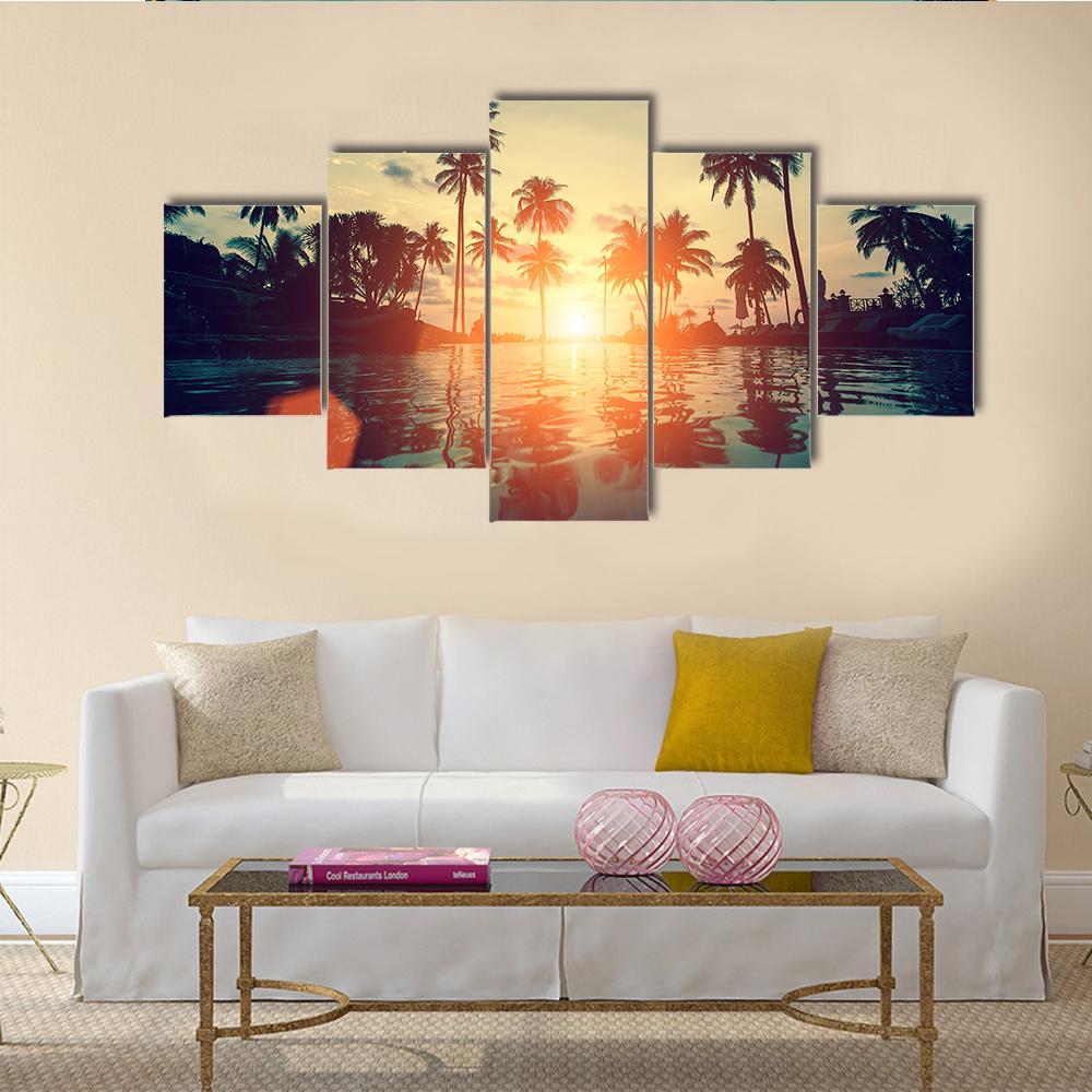 Sunset on Tropical Beach Canvas Wall Art in orange, yellow and blue, 5 panel Star layout hung on a wall
