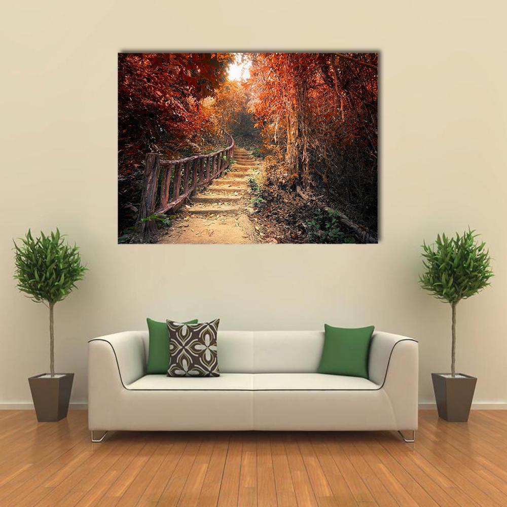 Autumn Forest Path with Sunlight Canvas Wall Art in brown, red and orange, single panel hung on a wall
