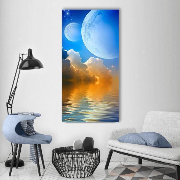 Twin Celestial Bodies Over Reflective Water Vertical Canvas Wall Art in orange, yellow and blue, single vertical panel hung on a wall