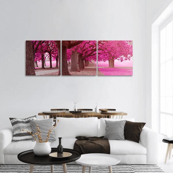 Park Path Through Pink Trees Panoramic Canvas Wall Art in gray, brown and pink, hung on a wall