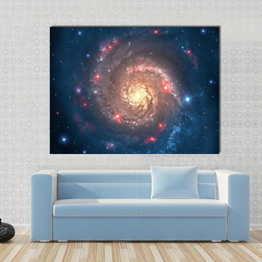 Spiral Galaxy with Golden Core Canvas Wall Art in black, gold and blue, single panel hung on a wall