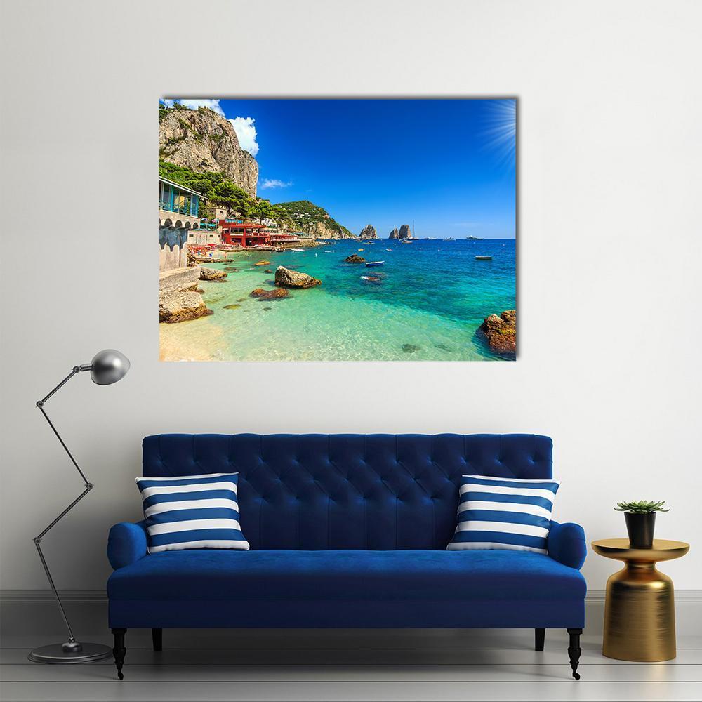 Faraglioni Cliffs and Beach Canvas Wall Art in brown, green and blue, single panel hung on a wall