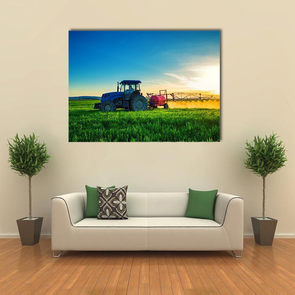 Tractor Plowing and Spraying in a Field Canvas Wall Art in yellow, green and blue, single panel hung on a wall