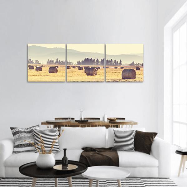Hay Bales in Harvest Field Panoramic Canvas Wall Art in beige, brown and yellow, hung on a wall