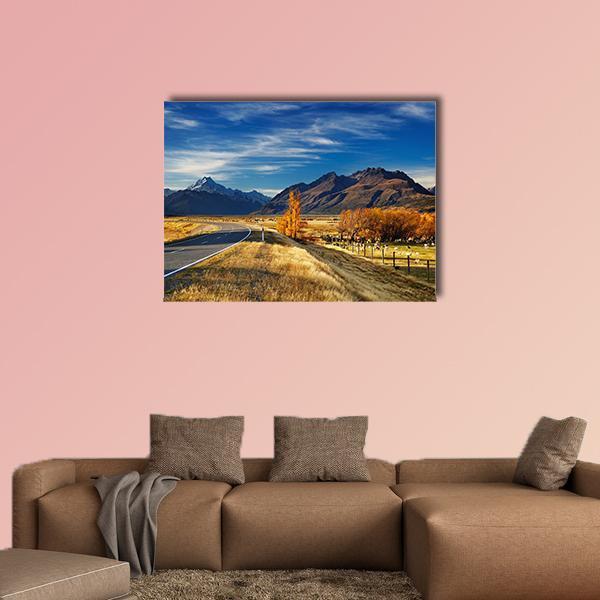 Farmland with Mount Cook Canvas Wall Art in brown, yellow and blue, single panel hung on a wall