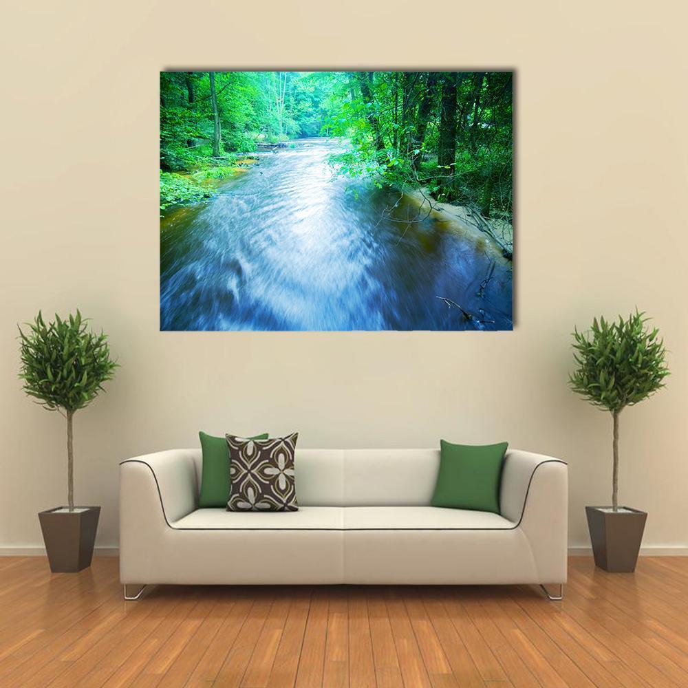 Fast Forest Stream Canvas Wall Art in green and blue, single panel hung on a wall