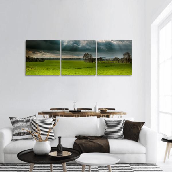 Sunbeams Over Lincolnshire Wolds Panoramic Canvas Wall Art in gray, green and blue, hung on a wall