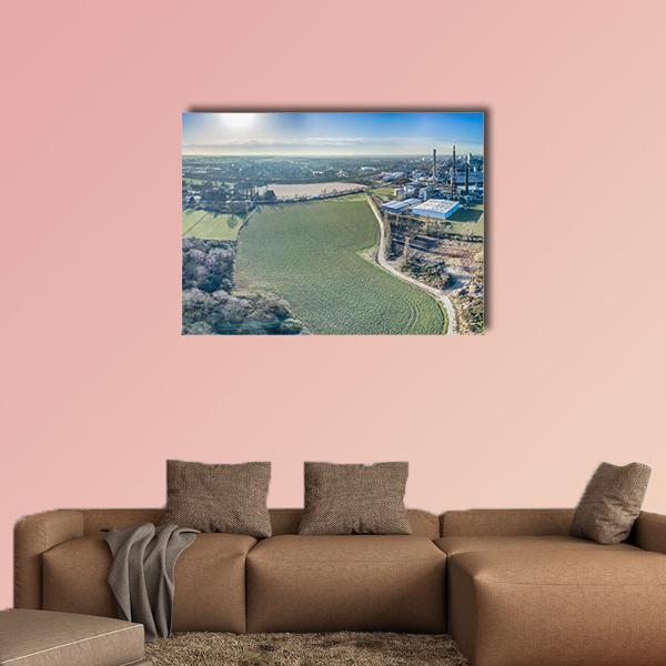 Aerial Fields with Smokestacks Canvas Wall Art in brown, green and blue, single panel hung on a wall