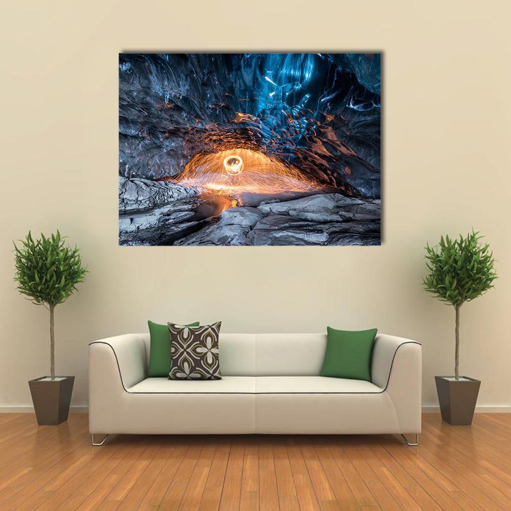 Fire Show in Ice Cave Canvas Wall Art in black, orange and blue, single panel hung on a wall