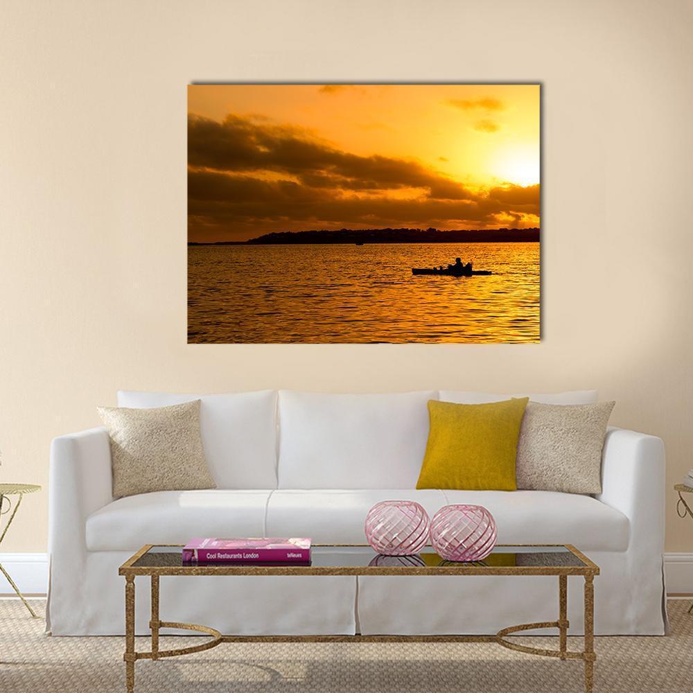 Kayakers at Sunset Canvas Wall Art in black, orange and yellow, single panel hung on a wall