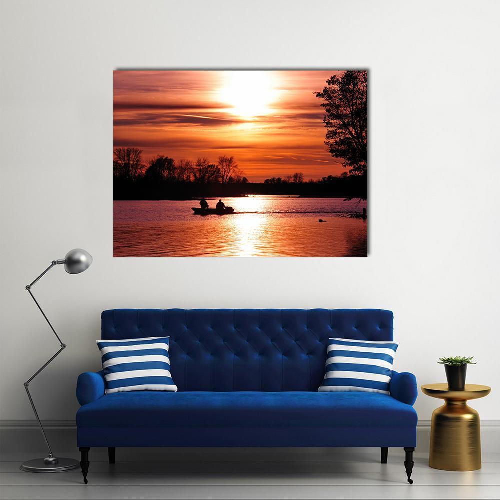 Sunset Fishing Boat Silhouettes Canvas Wall Art in black, red and orange, single panel hung on a wall