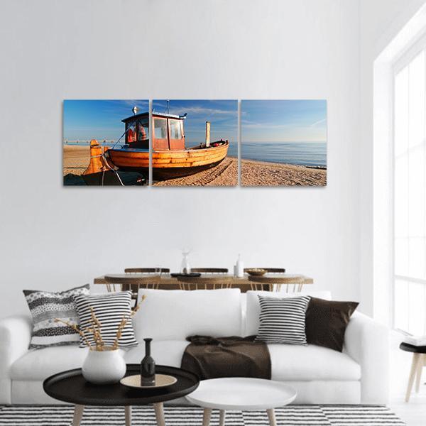 Wooden Fishing Boat on Sandy Beach Panoramic Canvas Wall Art in beige, brown and blue, hung on a wall