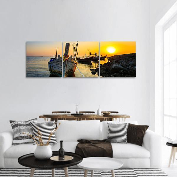 Fishing Boat at Sunset Panoramic Canvas Wall Art in orange, yellow and blue, hung on a wall