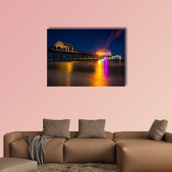 Fishing Pier at Night Canvas Wall Art in yellow, blue and navy, single panel hung on a wall