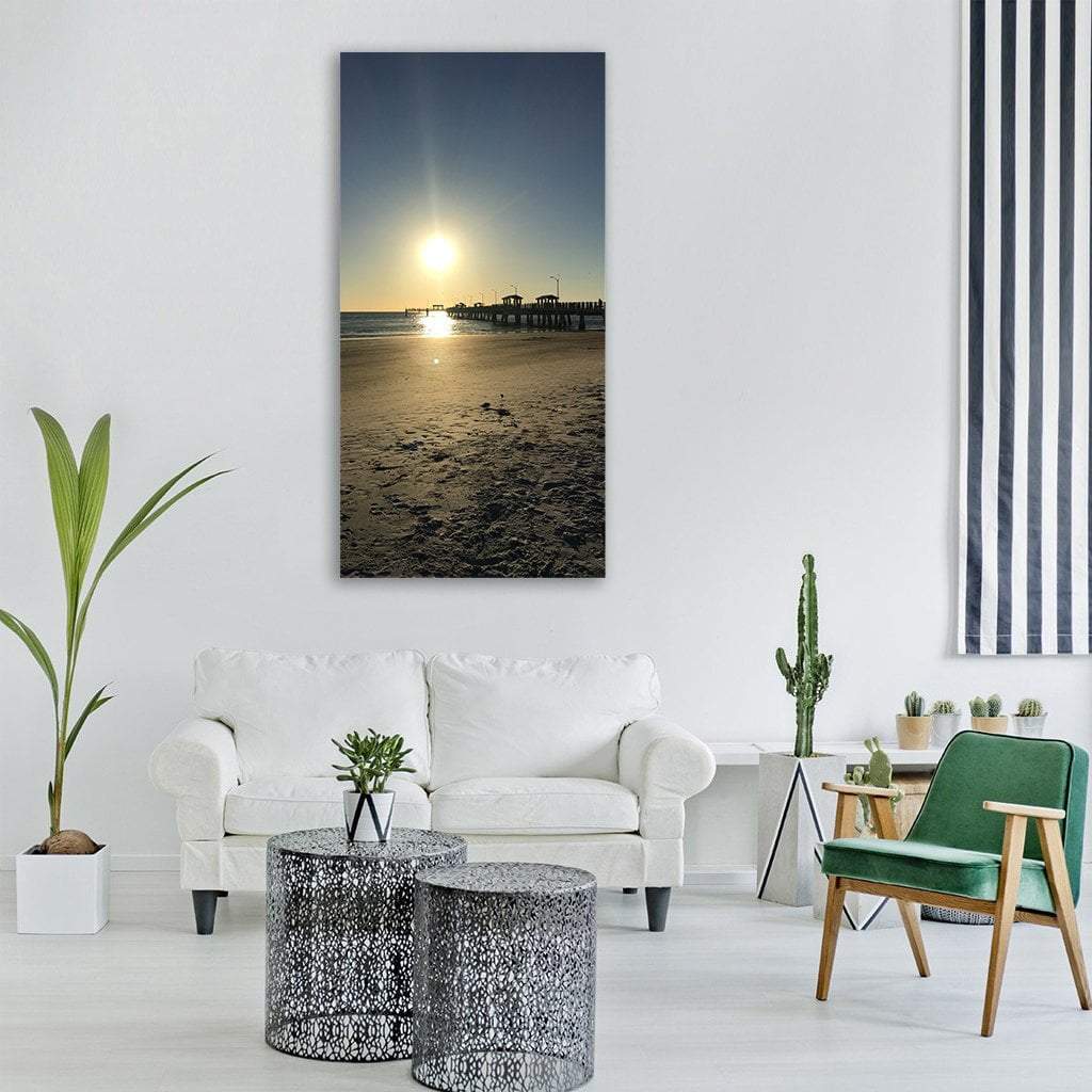 Fishing Pier at Sunset Vertical Canvas Wall Art in beige, yellow and blue, single vertical panel hung on a wall