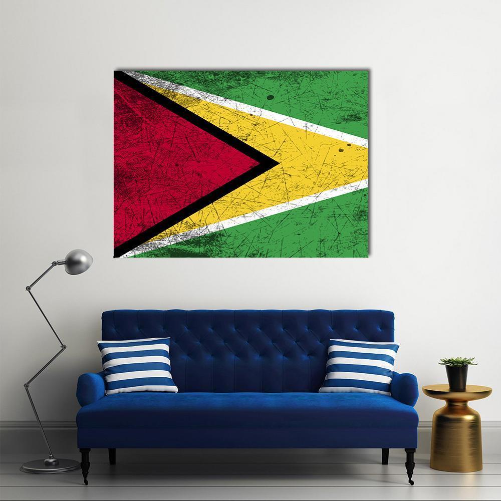 Distressed Guyana Flag Canvas Wall Art in red, yellow and green, single panel hung on a wall