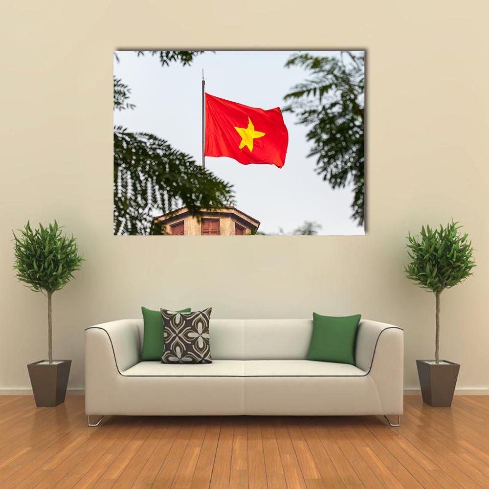 Vietnam Flag Over Tree-framed Rooftop Canvas Wall Art in white, red and green, single panel hung on a wall