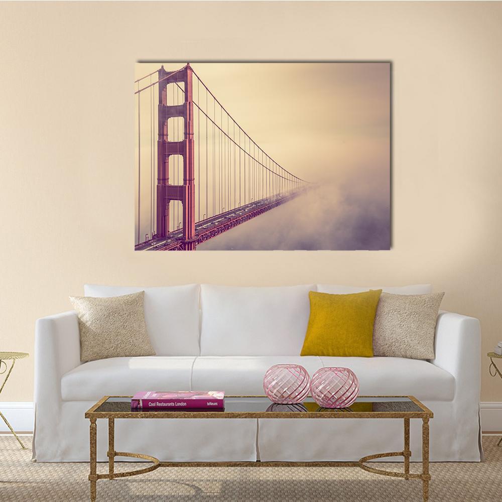 Foggy Red Suspension Bridge Canvas Wall Art in beige, red and purple, single panel hung on a wall