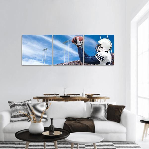 Football Player Catching a Pass Panoramic Canvas Wall Art in white, blue and navy, hung on a wall