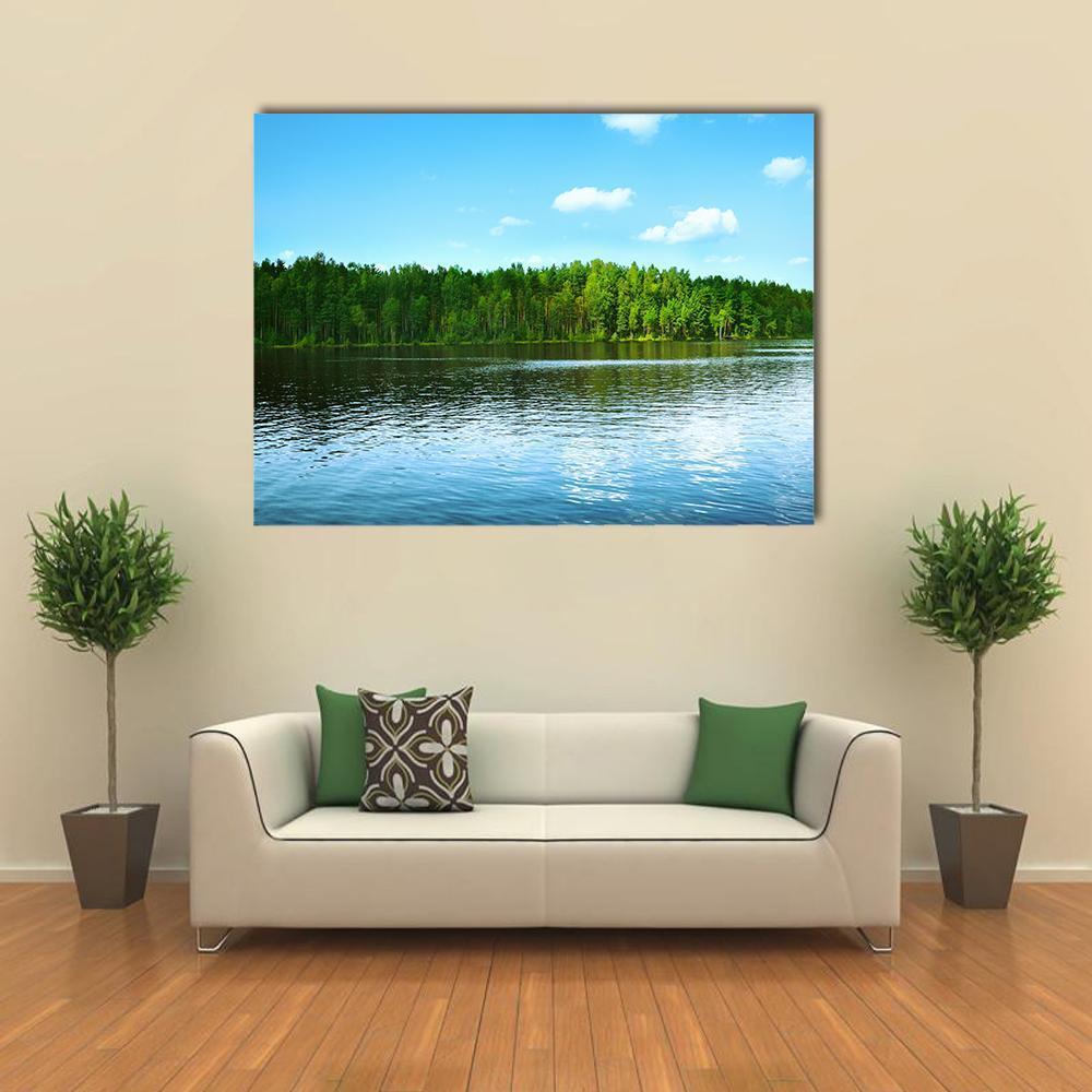 Forest and Lake with Treeline Reflection Canvas Wall Art in green and blue, single panel hung on a wall