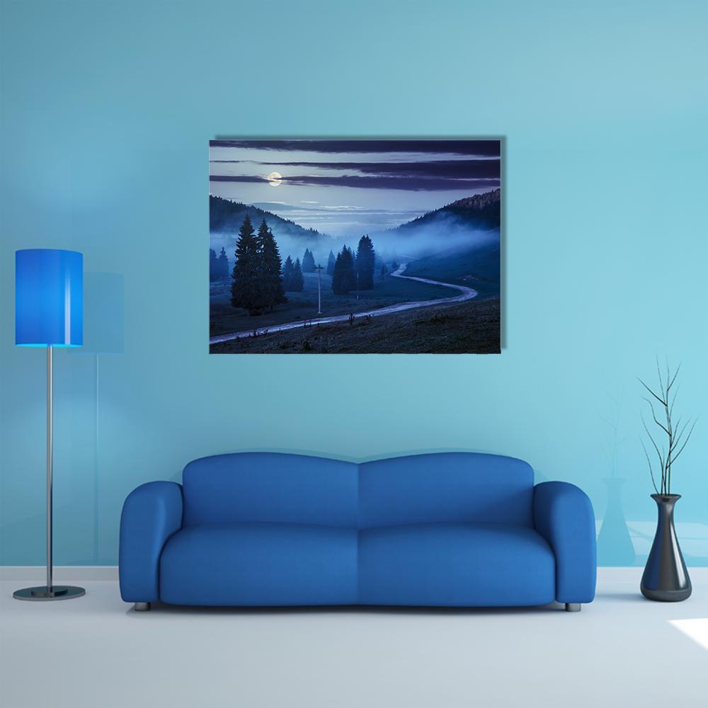 Forest Road Beneath Moonlit Fog Canvas Wall Art in black, blue and navy, single panel hung on a wall