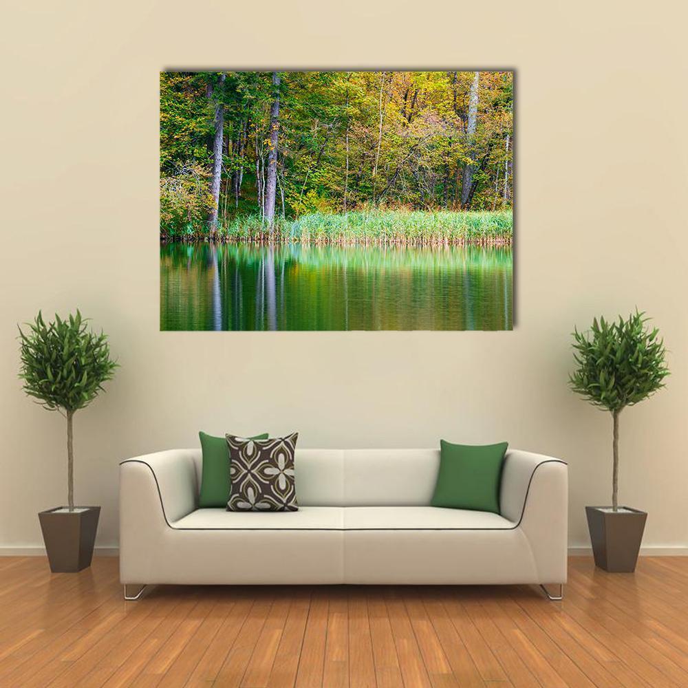 Autumn Reflection at Forest Lake Canvas Wall Art in brown, yellow and green, single panel hung on a wall
