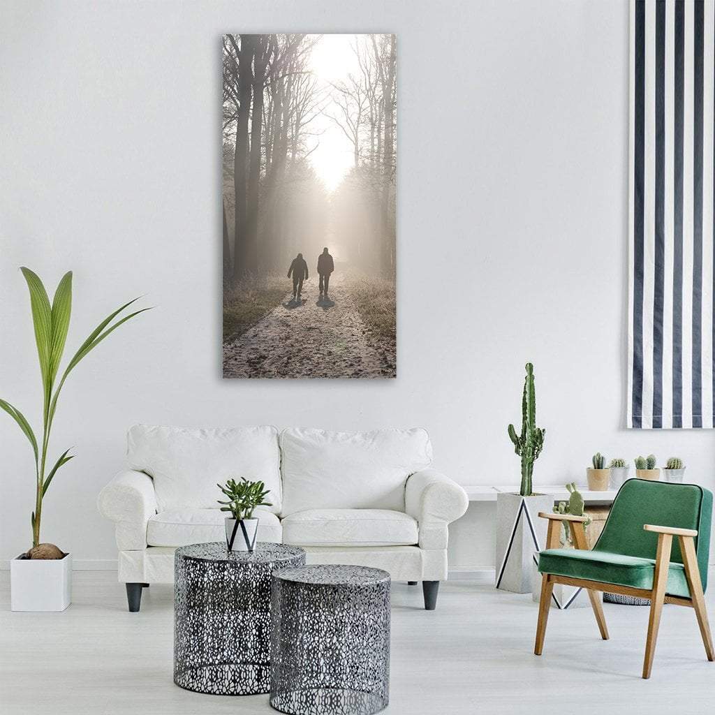 Two Silhouettes on Misty Forest Path Vertical Canvas Wall Art in black, white and gray, single vertical panel hung on a wall