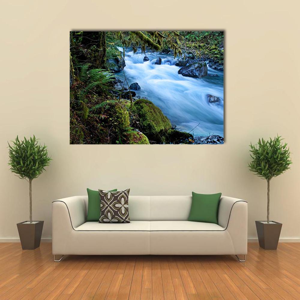 Silky Forest Stream with Mossy Rocks Canvas Wall Art in white, green and blue, single panel hung on a wall