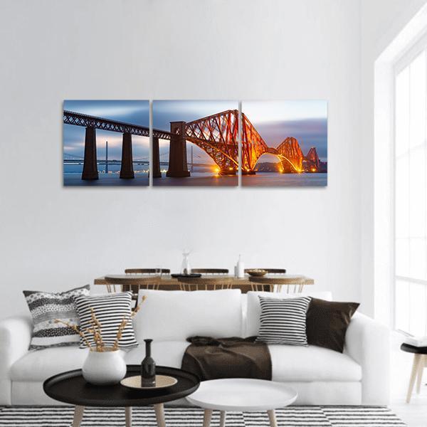 Forth Bridge Scotland at Dusk Panoramic Canvas Wall Art in gray, orange and blue, hung on a wall