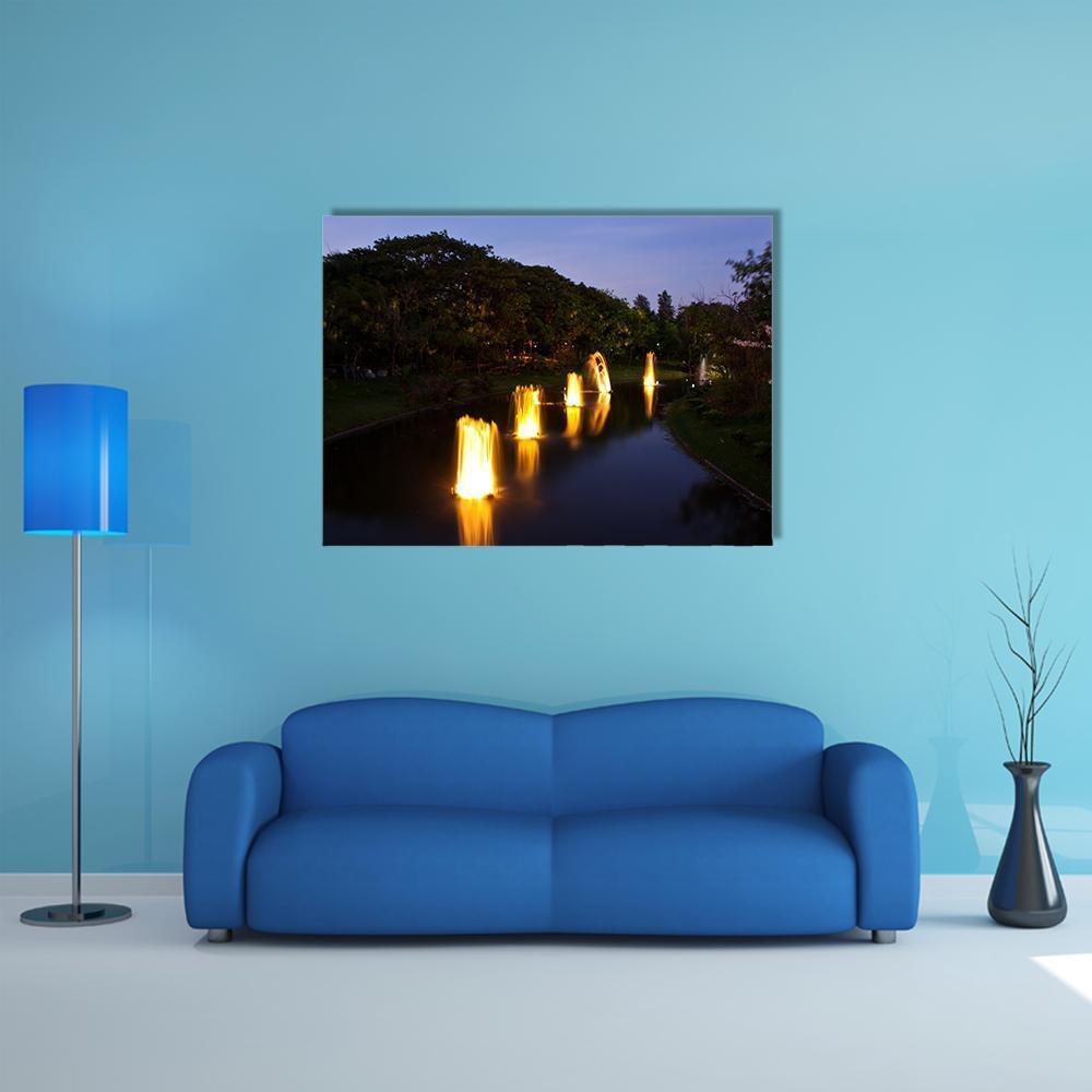 Garden Fountain at Night Canvas Wall Art in black, yellow and blue, single panel hung on a wall