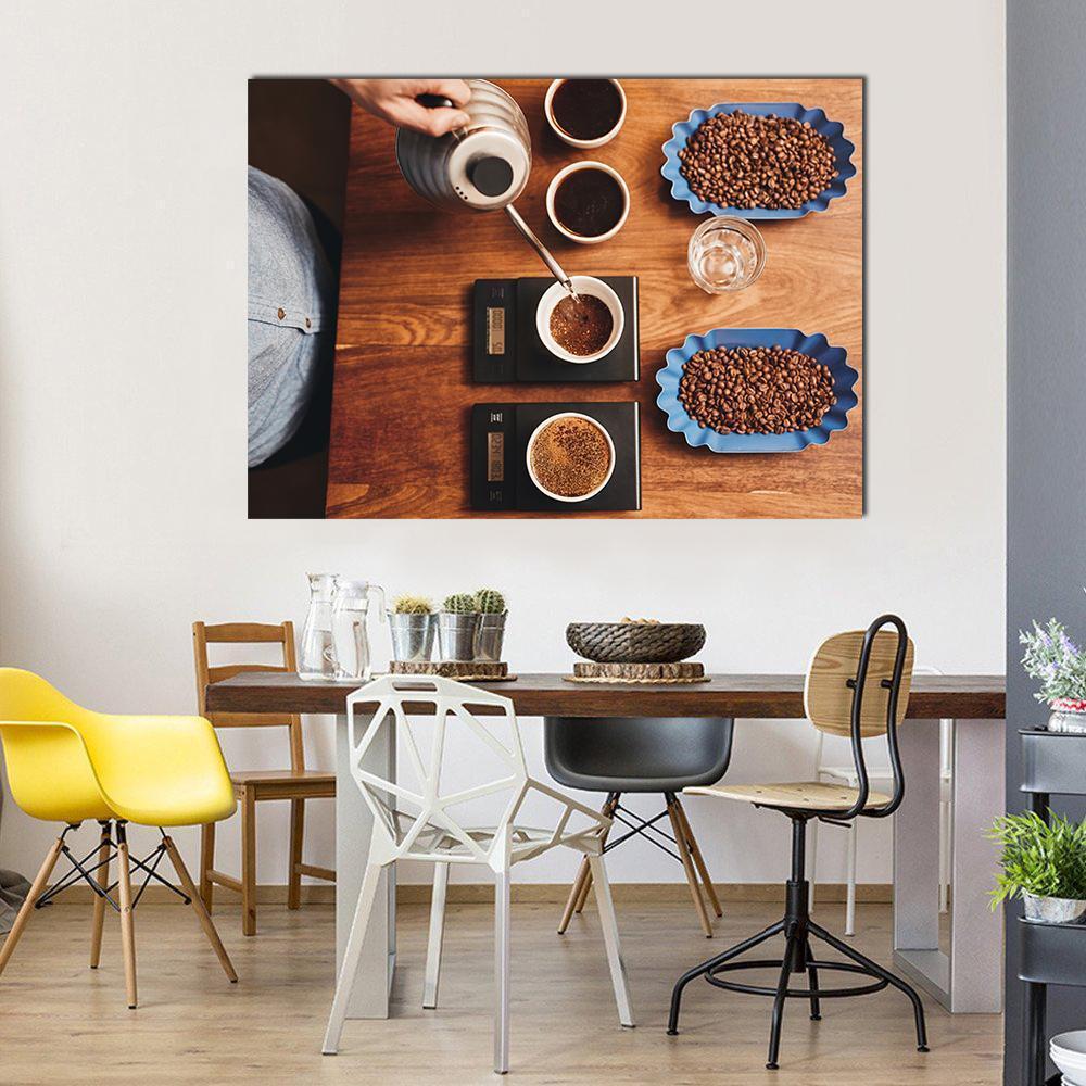 Four Coffee Cups on Table Canvas Wall Art in black, brown and blue, single panel hung on a wall
