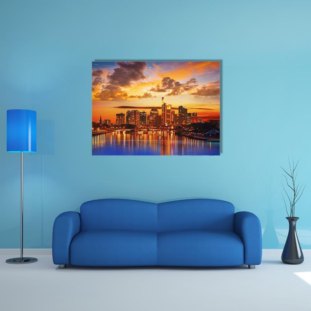 Frankfurt Skyline with River Reflections Canvas Wall Art in orange, yellow and blue, single panel hung on a wall