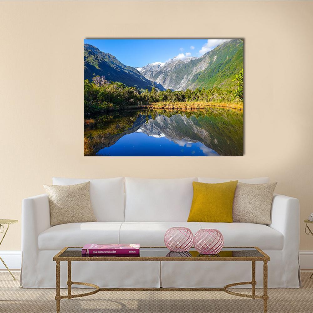 Franz Josef Glacier Reflected in Lake Canvas Wall Art in gray, green and blue, single panel hung on a wall