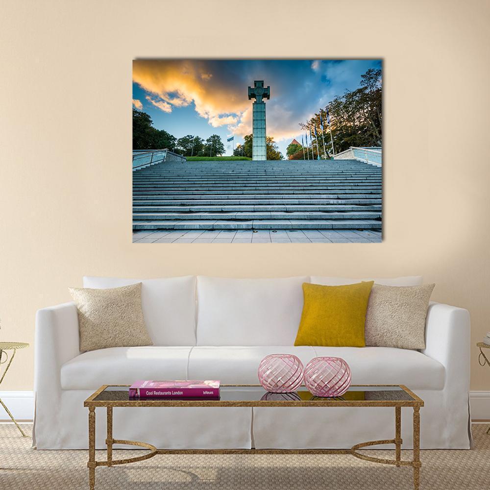 Freedom Square Cross Monument at Sunset Canvas Wall Art in gray, orange and blue, single panel hung on a wall