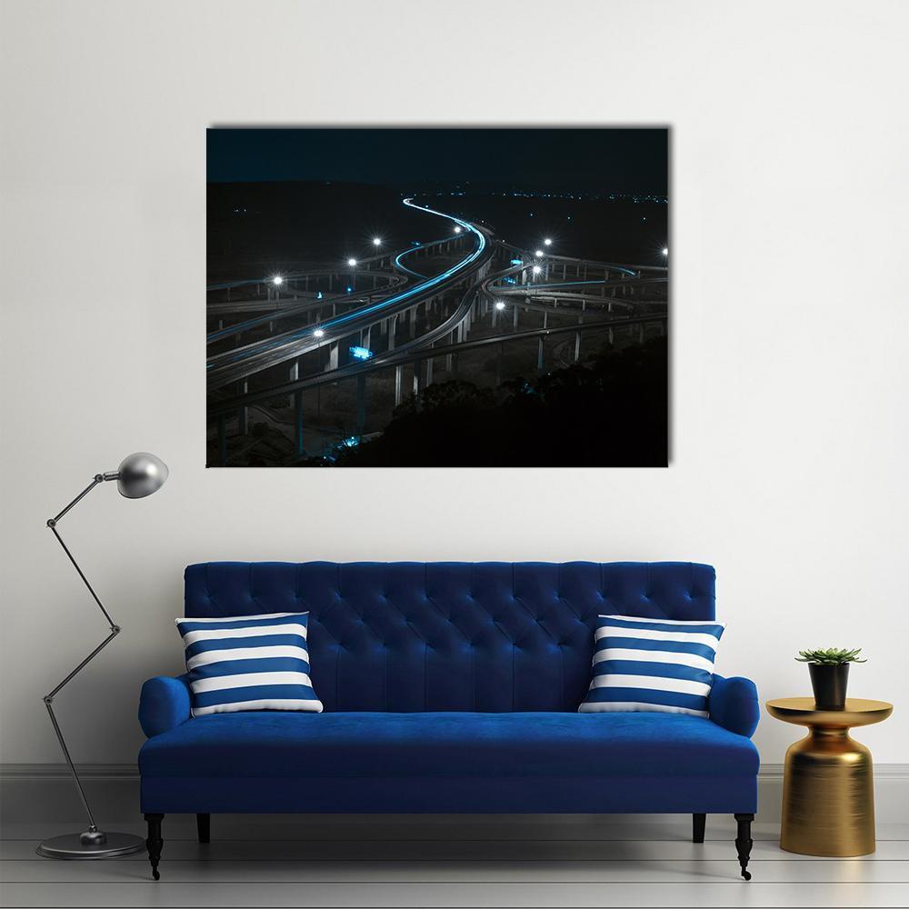 Highway Nights with Vehicle Light Trails Canvas Wall Art in black, gray and blue, single panel hung on a wall