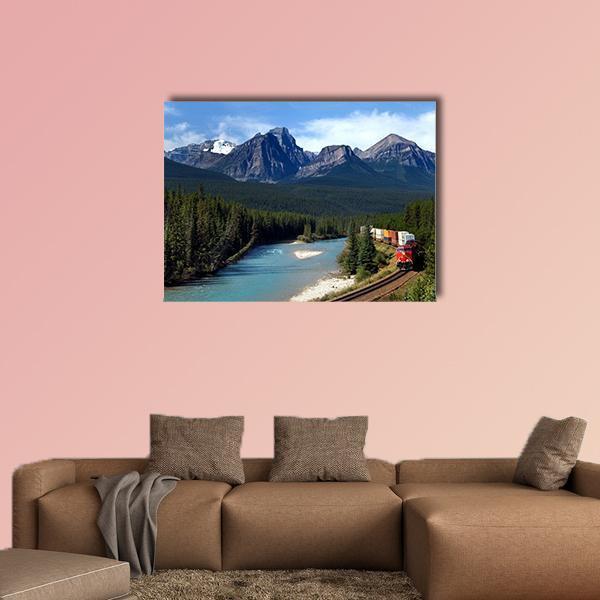 Train Along Bow River Canvas Wall Art in gray, green and blue, single panel hung on a wall
