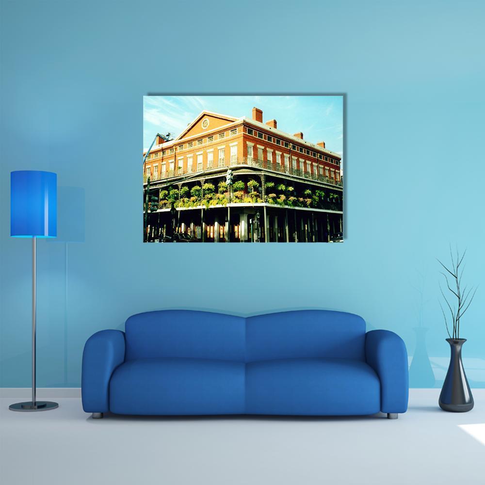 Ornate Balcony on Historic Brick Facade Canvas Wall Art in brown, orange and blue, single panel hung on a wall
