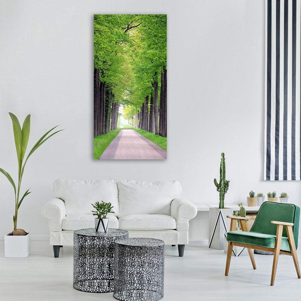 Friesland Forest Path Vertical Canvas Wall Art in gray, brown and green, single vertical panel hung on a wall