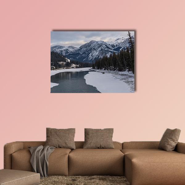 Frozen Maligne Lake with Snow-capped Peaks Canvas Wall Art in white, gray and blue, single panel hung on a wall