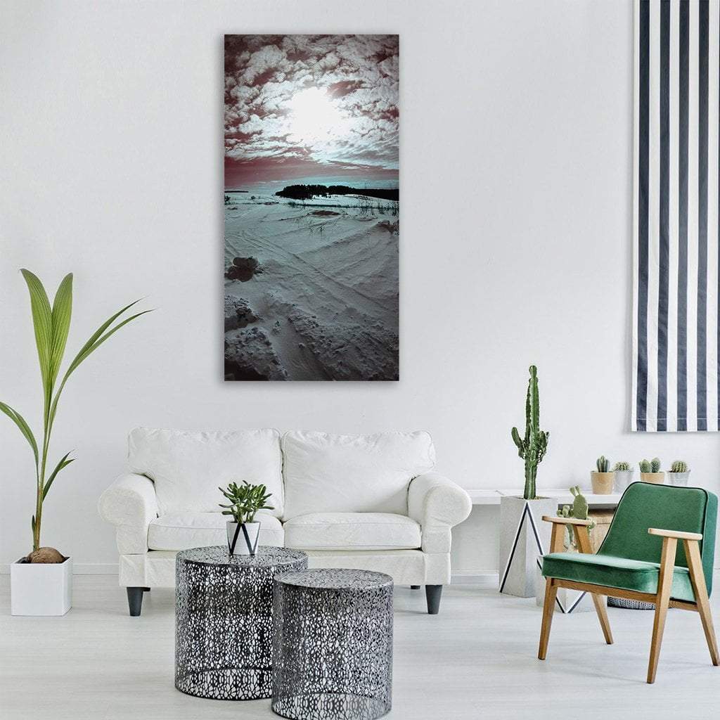 Snowy Field with Tire Tracks Vertical Canvas Wall Art in black, white and gray, single vertical panel hung on a wall