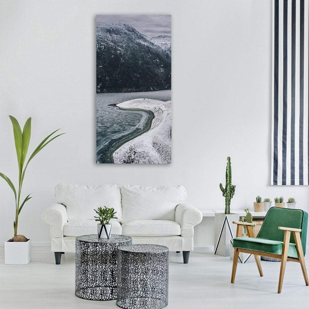 Frozen Shoreline and Snow-dusted Mountains Vertical Canvas Wall Art in black, white and gray, single vertical panel hung on a wall
