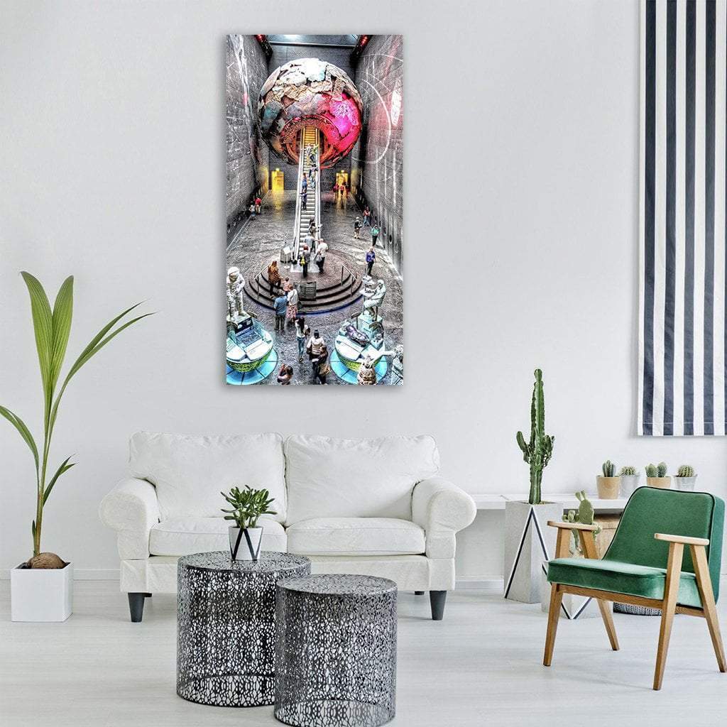 Spherical Sculpture in Science Museum Lobby Vertical Canvas Wall Art in gray, pink and multicolor, single vertical panel hung on a wall