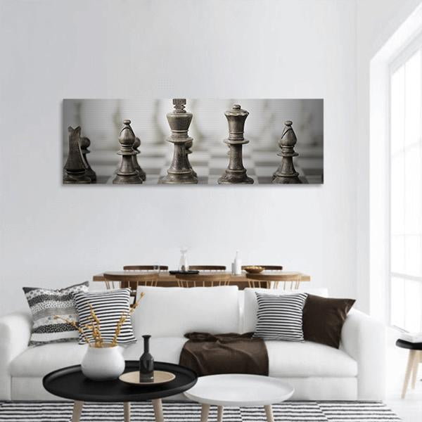 Sepia Metallic Chess Pieces on Chessboard Panoramic Canvas Wall Art in gray and brown, hung on a wall