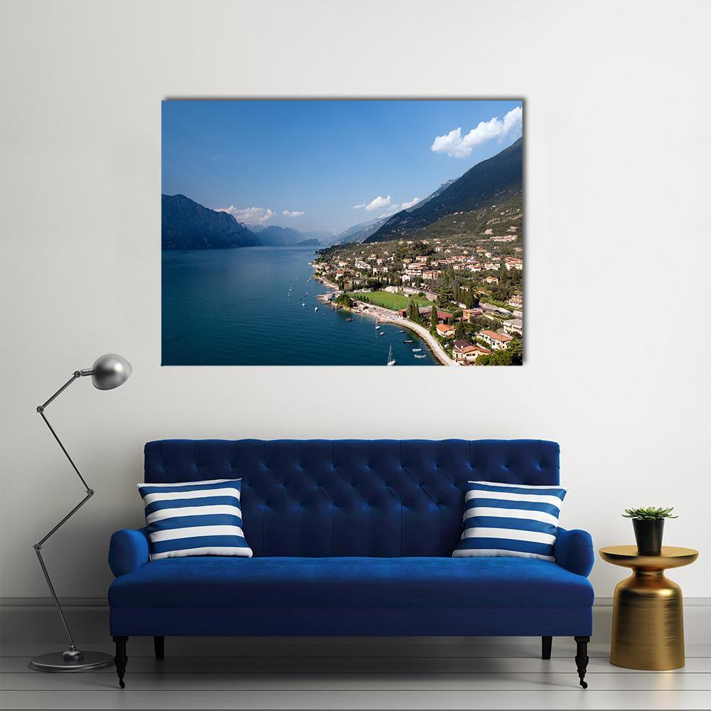 Garda Lake Italy Lakeside Town and Mountains Canvas Wall Art in green and blue, single panel hung on a wall