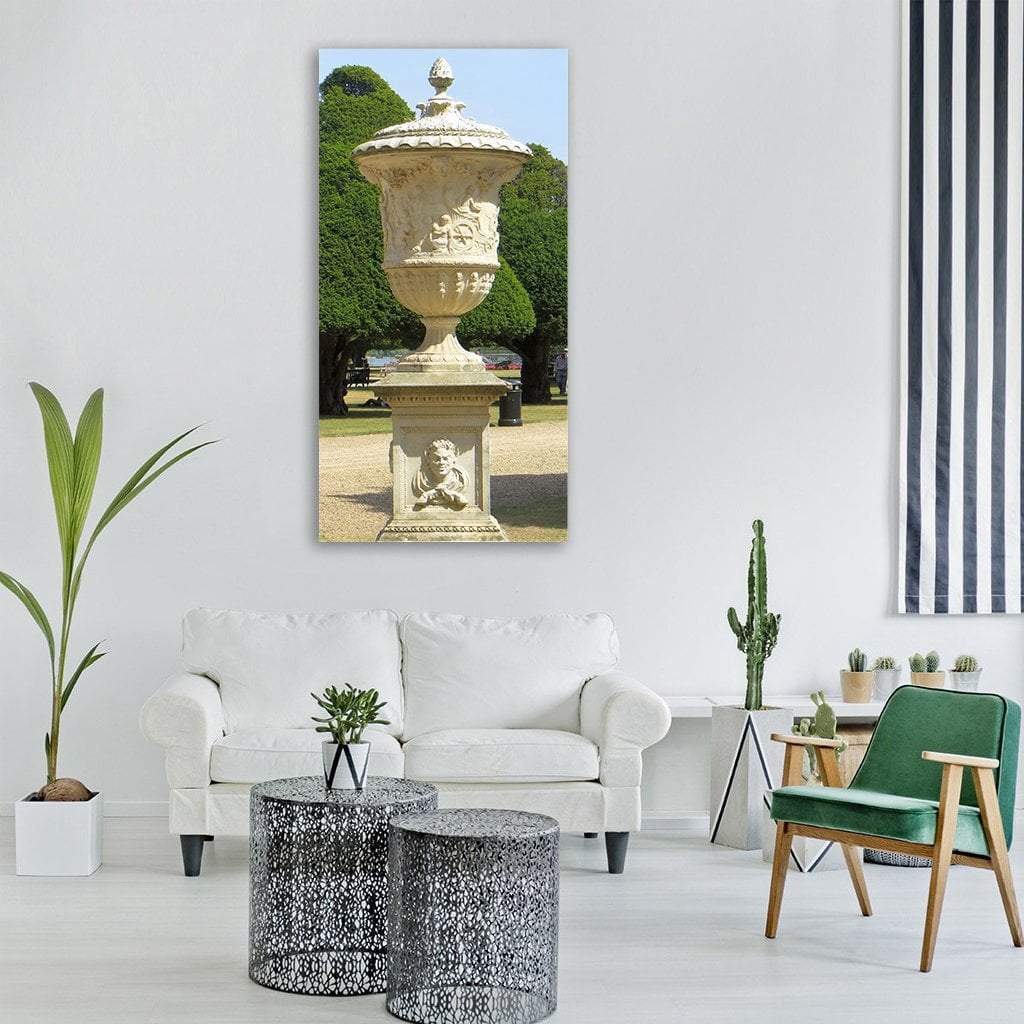 Ornate Stone Urn in Formal Garden Vertical Canvas Wall Art in gray, beige and green, hung on a wall